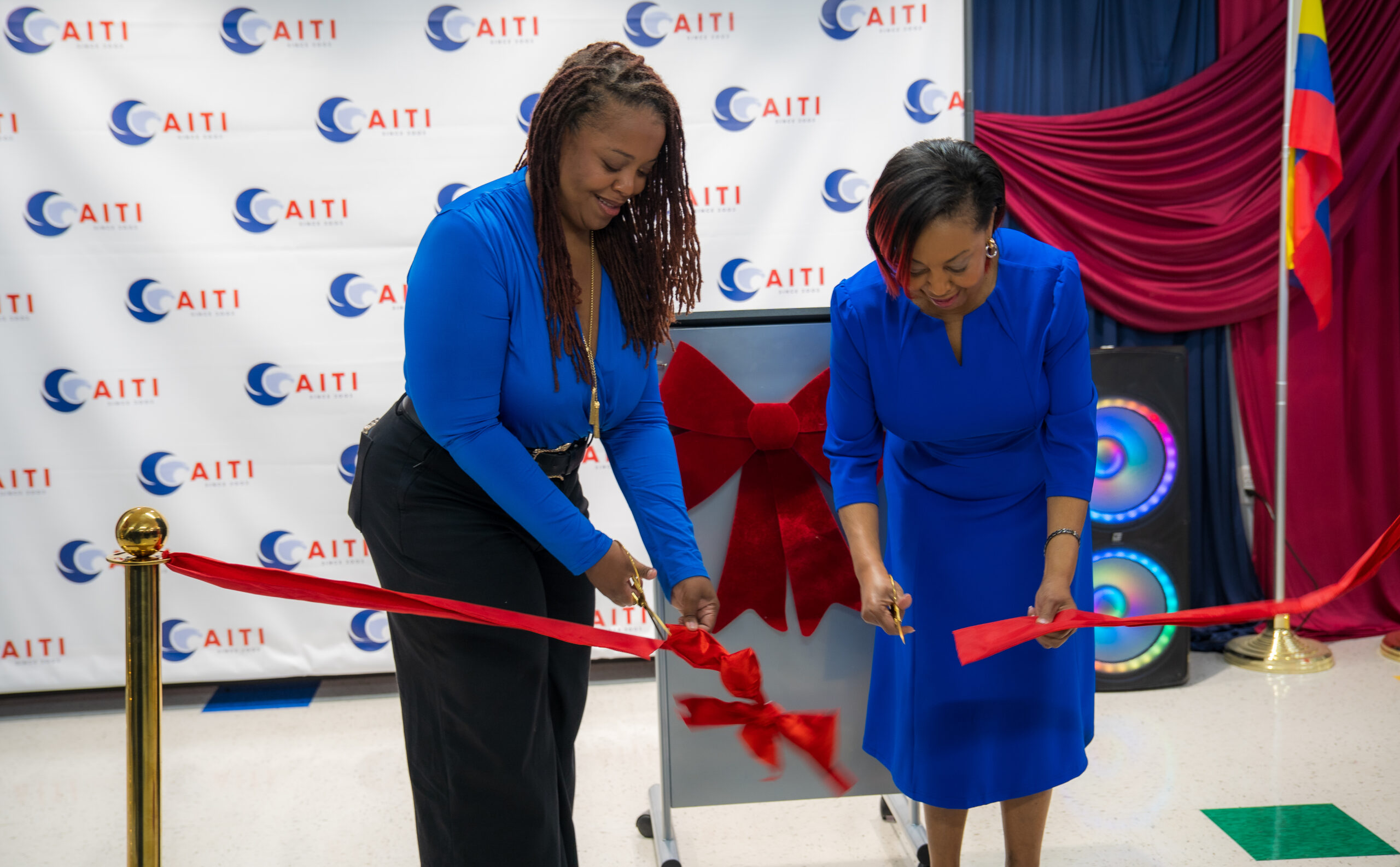 Participants cutting a red ribbon during AITI’s new campus ribbon-cutting ceremony in Tampa.
